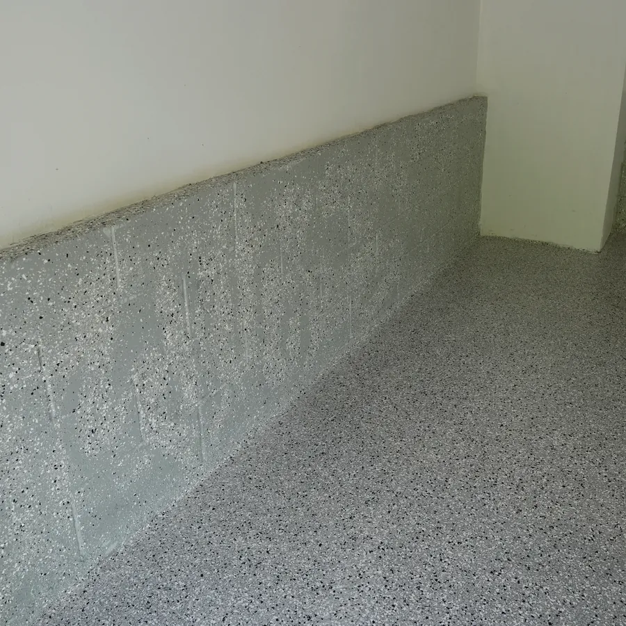 After: coated wall base and dark flake epoxy floor