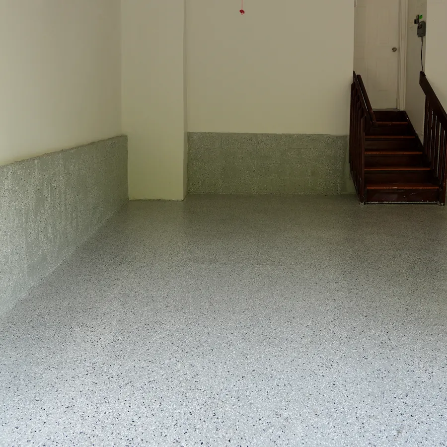 After: the same garage with seamless flake epoxy floor and coated walls