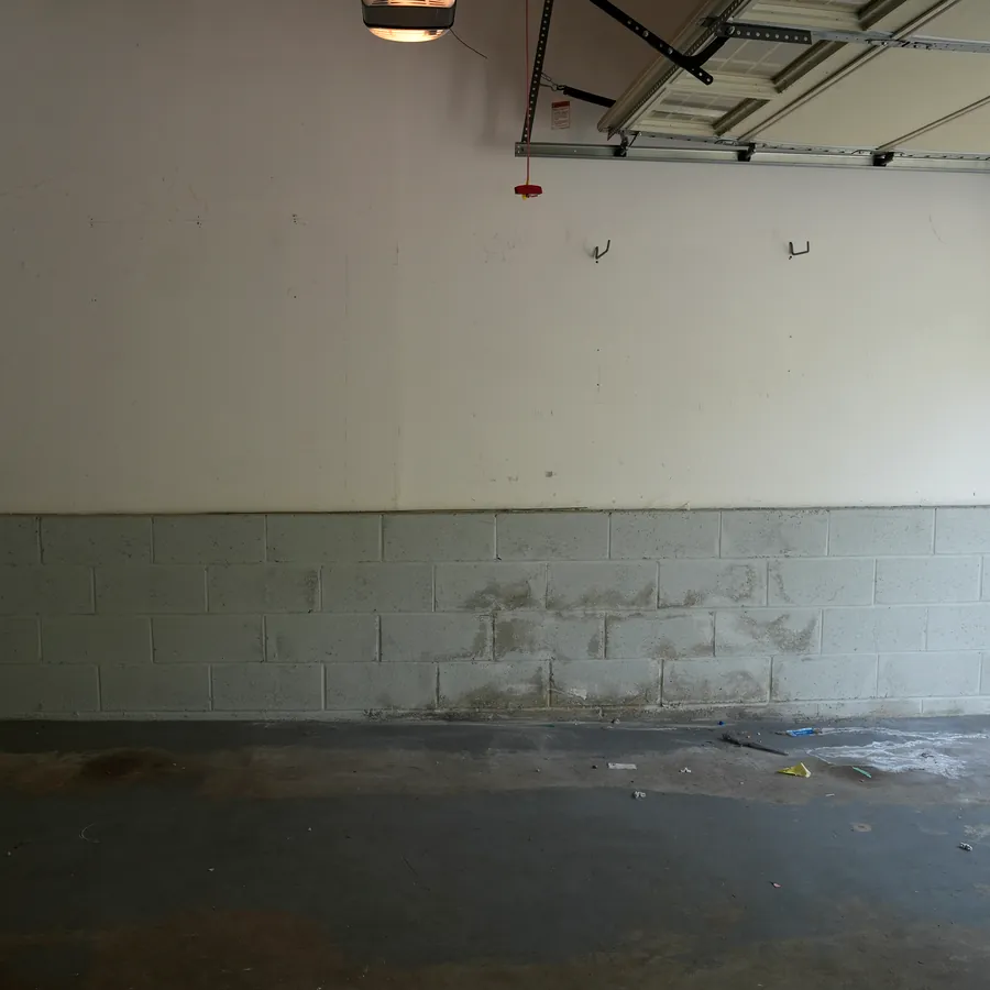 Before: grimy block wall and stained concrete floor